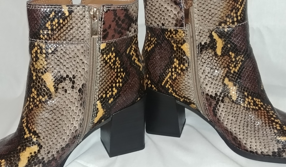 Franco Sarto snake print boots.Lether uppers .